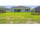 A beautifully maintained backyard features lush green grass and a neutral-toned home exterior at 6126 Hidden Branch Dr, Apollo Beach, FL 33572
