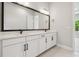 Bathroom with double sinks, quartz countertops, and a large mirror at 6126 Hidden Branch Dr, Apollo Beach, FL 33572