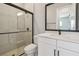Modern bathroom featuring a glass-enclosed shower, white vanity, and black hardware at 6126 Hidden Branch Dr, Apollo Beach, FL 33572