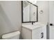 Modern bathroom with white vanity, black hardware, and a large mirror at 6126 Hidden Branch Dr, Apollo Beach, FL 33572