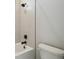 Clean bathroom with a tiled bathtub and shower combination with modern fixtures at 6126 Hidden Branch Dr, Apollo Beach, FL 33572