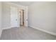 Bedroom with walk-in closet and ensuite bath, featuring white doors and neutral carpeting at 6126 Hidden Branch Dr, Apollo Beach, FL 33572