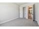 Bedroom with walk-in closet and ensuite bath, featuring white doors and neutral carpeting at 6126 Hidden Branch Dr, Apollo Beach, FL 33572