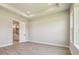Neutral bedroom with tray ceiling, bright natural light, and a door leading to an ensuite bathroom at 6126 Hidden Branch Dr, Apollo Beach, FL 33572