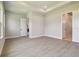 Spacious bedroom featuring wood-look floors and modern recessed lighting at 6126 Hidden Branch Dr, Apollo Beach, FL 33572