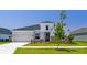 Attractive home with vertical siding, stone accents, black trim, and fresh landscaping enhancing curb appeal at 6126 Hidden Branch Dr, Apollo Beach, FL 33572