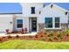 Charming home featuring stone accents, complemented by colorful landscaping and a well-maintained lawn at 6126 Hidden Branch Dr, Apollo Beach, FL 33572