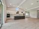 Bright, open living area with modern kitchen appliances, an island, and ample counter space at 6126 Hidden Branch Dr, Apollo Beach, FL 33572