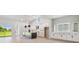 Modern kitchen features white cabinets, dark island, stainless appliances, and abundant natural light at 6126 Hidden Branch Dr, Apollo Beach, FL 33572