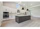 Open-concept kitchen with a large island, stainless steel appliances, and ample cabinet space at 6126 Hidden Branch Dr, Apollo Beach, FL 33572
