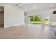 Bright living area with large glass windows and doors offers serene views of lush landscaping at 6126 Hidden Branch Dr, Apollo Beach, FL 33572