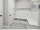 Mudroom featuring built-in bench and storage, with eye-catching patterned tile floors at 6126 Hidden Branch Dr, Apollo Beach, FL 33572
