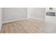 Room with neutral walls, light-colored flooring, and a glimpse into the open floor plan at 6126 Hidden Branch Dr, Apollo Beach, FL 33572