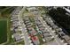 Aerial view of a community with rows of houses and a community pool at 6444 Bar S Bar Trl, Zephyrhills, FL 33541