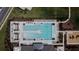 Aerial view showcasing the community pool, playground, and surrounding green spaces at 6444 Bar S Bar Trl, Zephyrhills, FL 33541