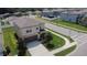 Aerial view of a charming two-story home with two car garage, lush trees, and luscious landscaping at 6444 Bar S Bar Trl, Zephyrhills, FL 33541