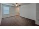 Bedroom featuring a carpeted floor, ceiling fan and window for natural light at 6444 Bar S Bar Trl, Zephyrhills, FL 33541