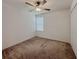Simple bedroom with carpet flooring, ceiling fan, and closet at 6444 Bar S Bar Trl, Zephyrhills, FL 33541
