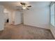 Spacious bedroom with neutral walls, plush carpeting, ceiling fan, and natural light at 6444 Bar S Bar Trl, Zephyrhills, FL 33541