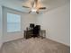 Bright bedroom with a ceiling fan, window, and a desk workstation setup at 6444 Bar S Bar Trl, Zephyrhills, FL 33541