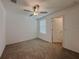 Bedroom with a ceiling fan, carpet flooring, and a window at 6444 Bar S Bar Trl, Zephyrhills, FL 33541