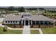 Exterior shot of the community clubhouse with manicured landscaping and a welcoming entrance at 6444 Bar S Bar Trl, Zephyrhills, FL 33541