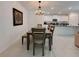 Dining room featuring a stylish chandelier and a view into the bright, modern kitchen at 6444 Bar S Bar Trl, Zephyrhills, FL 33541