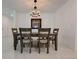 Dining room showcases a modern table setting beneath an elegant chandelier, great for entertaining at 6444 Bar S Bar Trl, Zephyrhills, FL 33541