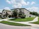 Charming two-story home featuring a two-car garage, manicured landscaping, and lush green lawn at 6444 Bar S Bar Trl, Zephyrhills, FL 33541