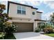 Charming two-story home featuring a covered entry, a two car garage, and manicured landscaping at 6444 Bar S Bar Trl, Zephyrhills, FL 33541