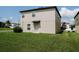 Back yard featuring a large green lawn and a partial view of the back of the home at 6444 Bar S Bar Trl, Zephyrhills, FL 33541