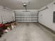 Spacious two car garage with neutral painted walls and concrete flooring at 6444 Bar S Bar Trl, Zephyrhills, FL 33541