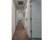 Carpeted hallway with white trim and doors providing access to other rooms at 6444 Bar S Bar Trl, Zephyrhills, FL 33541