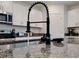 Close-up of the modern kitchen island featuring granite countertops and a stylish, functional faucet at 6444 Bar S Bar Trl, Zephyrhills, FL 33541