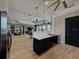 Kitchen area with stainless steel appliances, modern pendant lighting, and a view of the adjacent seating area at 6444 Bar S Bar Trl, Zephyrhills, FL 33541