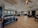Open-concept living room features wood-look floors, modern ceiling fans, recessed lighting, and plenty of natural light at 6444 Bar S Bar Trl, Zephyrhills, FL 33541