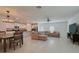 Spacious open-concept living room and kitchen with modern decor and plenty of natural light at 6444 Bar S Bar Trl, Zephyrhills, FL 33541