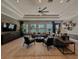 Cozy community lounge featuring comfortable seating, a large TV, and a view of the pool at 6444 Bar S Bar Trl, Zephyrhills, FL 33541