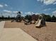 Community playground with slides and climbing structures set on a mulch ground, perfect for outdoor fun at 6444 Bar S Bar Trl, Zephyrhills, FL 33541