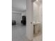 A view from living area into a white powder room with pedestal sink and tile flooring at 6444 Bar S Bar Trl, Zephyrhills, FL 33541