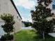 Side yard featuring lush green grass between homes with partial views of the sky at 6444 Bar S Bar Trl, Zephyrhills, FL 33541