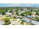 Aerial view showcasing a neighborhood with lush greenery and various house designs, highlighting community layout and serene residential living at 6875 11Th N Ave, St Petersburg, FL 33710