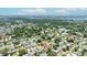 Aerial photograph shows residential neighborhood showcasing houses surrounded by lush trees with a body of water, pin indicates the address at 6875 11Th N Ave, St Petersburg, FL 33710