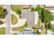 Overhead view of a home displaying its roof design, driveway, and yard layout within a residential area at 6875 11Th N Ave, St Petersburg, FL 33710