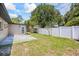 Backyard featuring a lawn, white fence, and access to the home's exterior at 6875 11Th N Ave, St Petersburg, FL 33710
