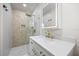 Modern bathroom featuring a glass shower, a quartz countertop, and gold fixtures at 6875 11Th N Ave, St Petersburg, FL 33710