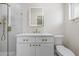 Bright bathroom featuring a quartz countertop, an illuminated mirror, and a glass shower at 6875 11Th N Ave, St Petersburg, FL 33710