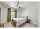 Cozy bedroom features a twin-sized bed, a side table, and a window with green curtains at 6875 11Th N Ave, St Petersburg, FL 33710