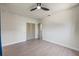 Bright bedroom features wood-look floors, ceiling fan and closet with louvered doors at 6875 11Th N Ave, St Petersburg, FL 33710