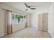 Bedroom has a ceiling fan, a large window, and natural light at 6875 11Th N Ave, St Petersburg, FL 33710
